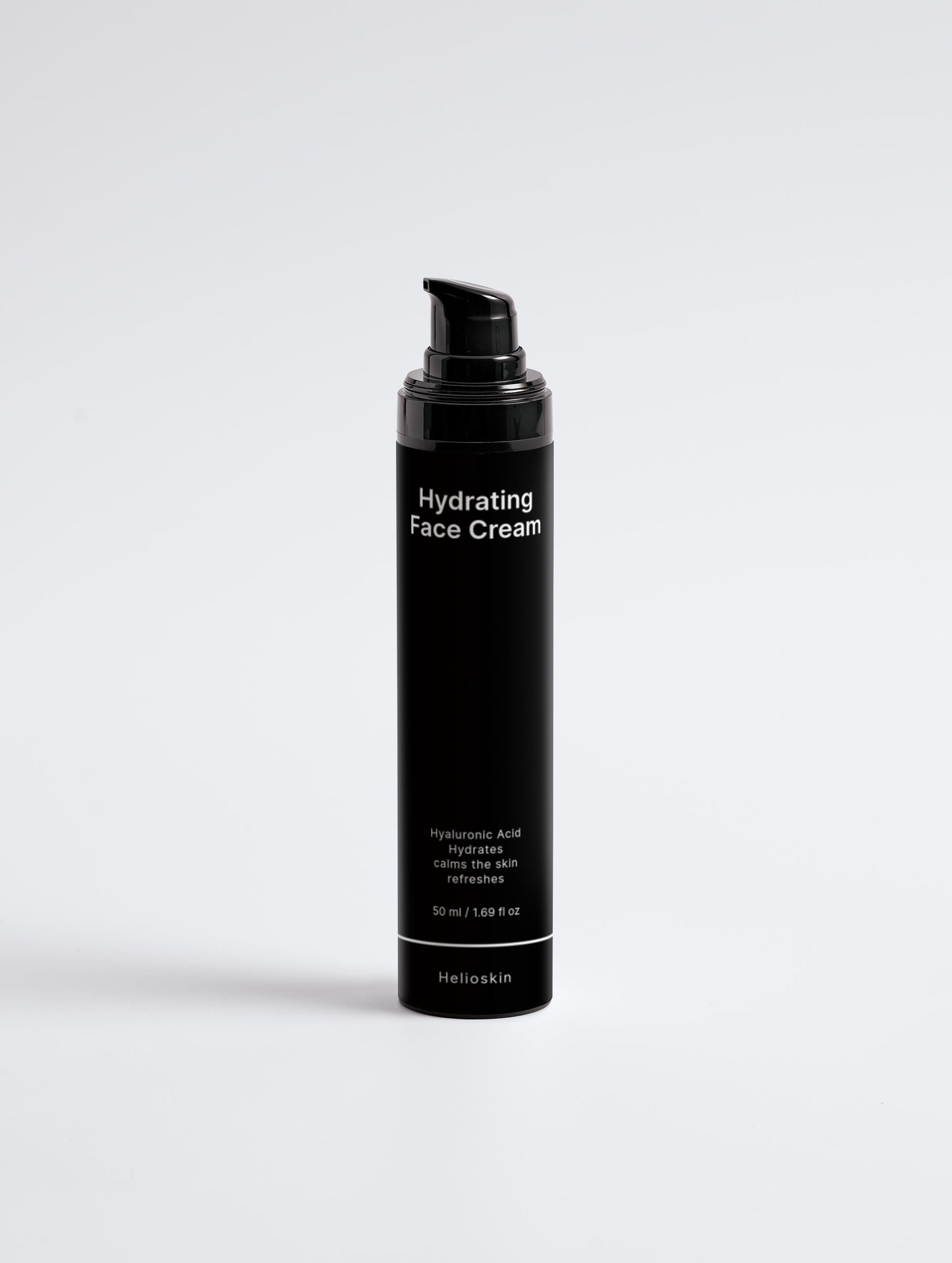 Black bottle of hydrating face cream on a light gray background