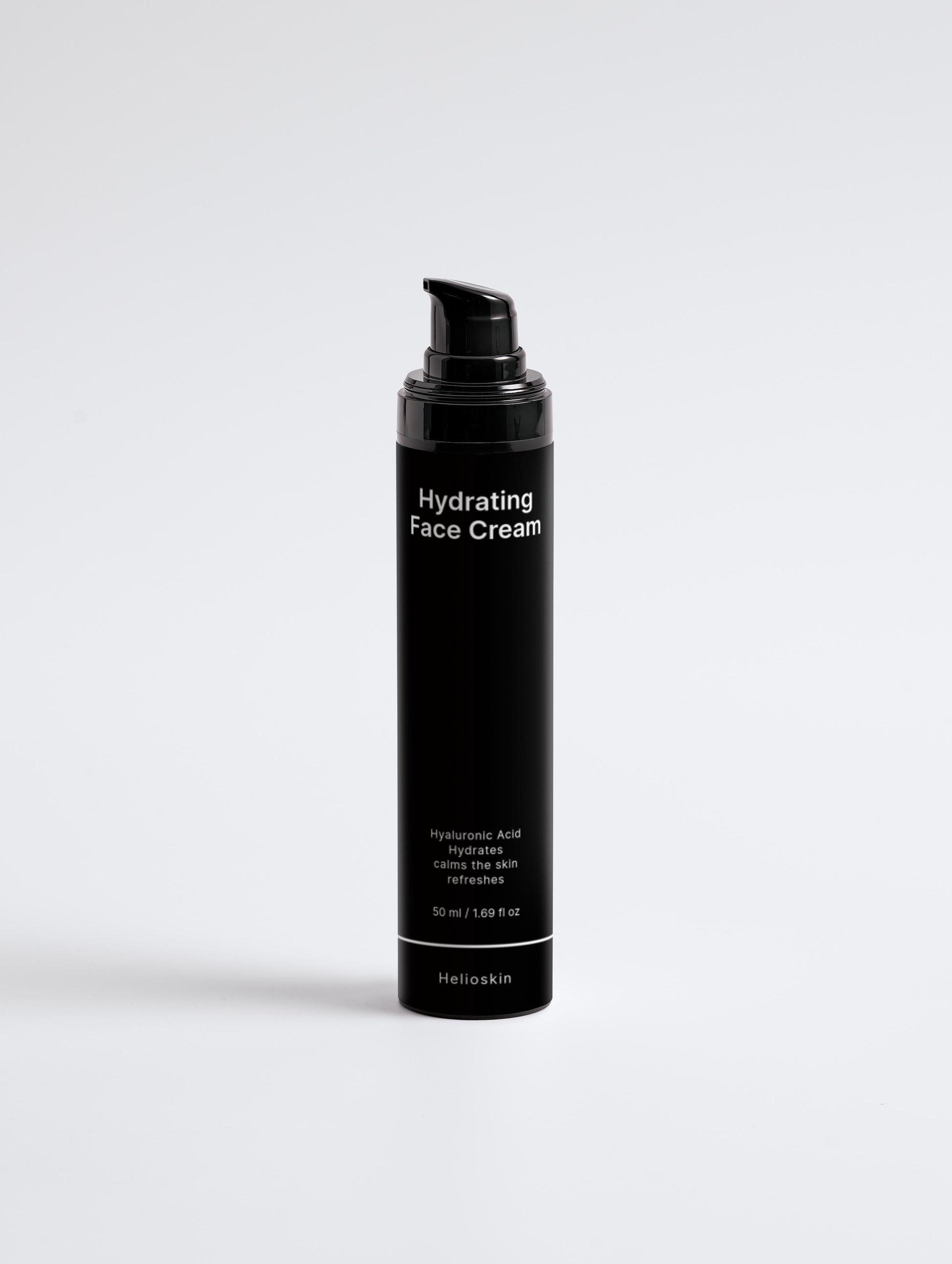 Black bottle of hydrating face cream on a light gray background