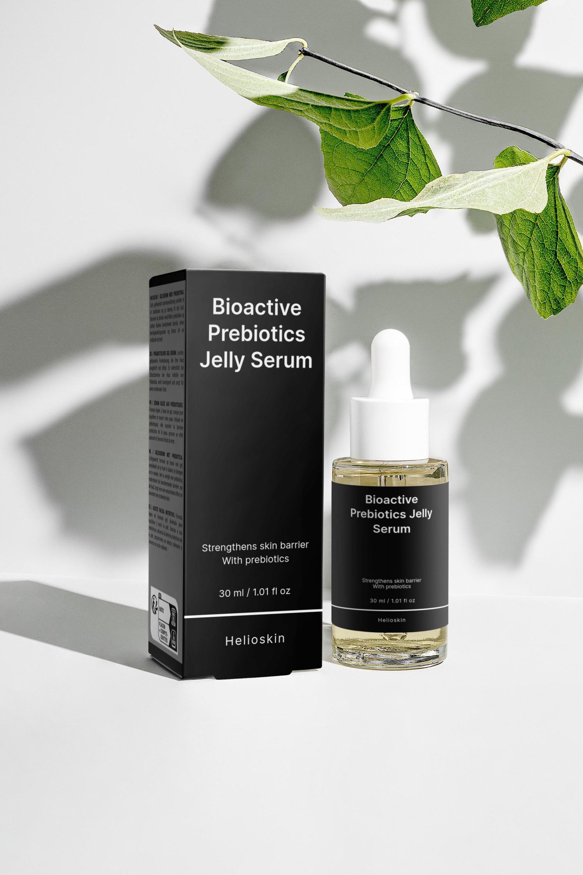 Bioactive Prebiotics Jelly Serum bottle and packaging with green leaves on a light background