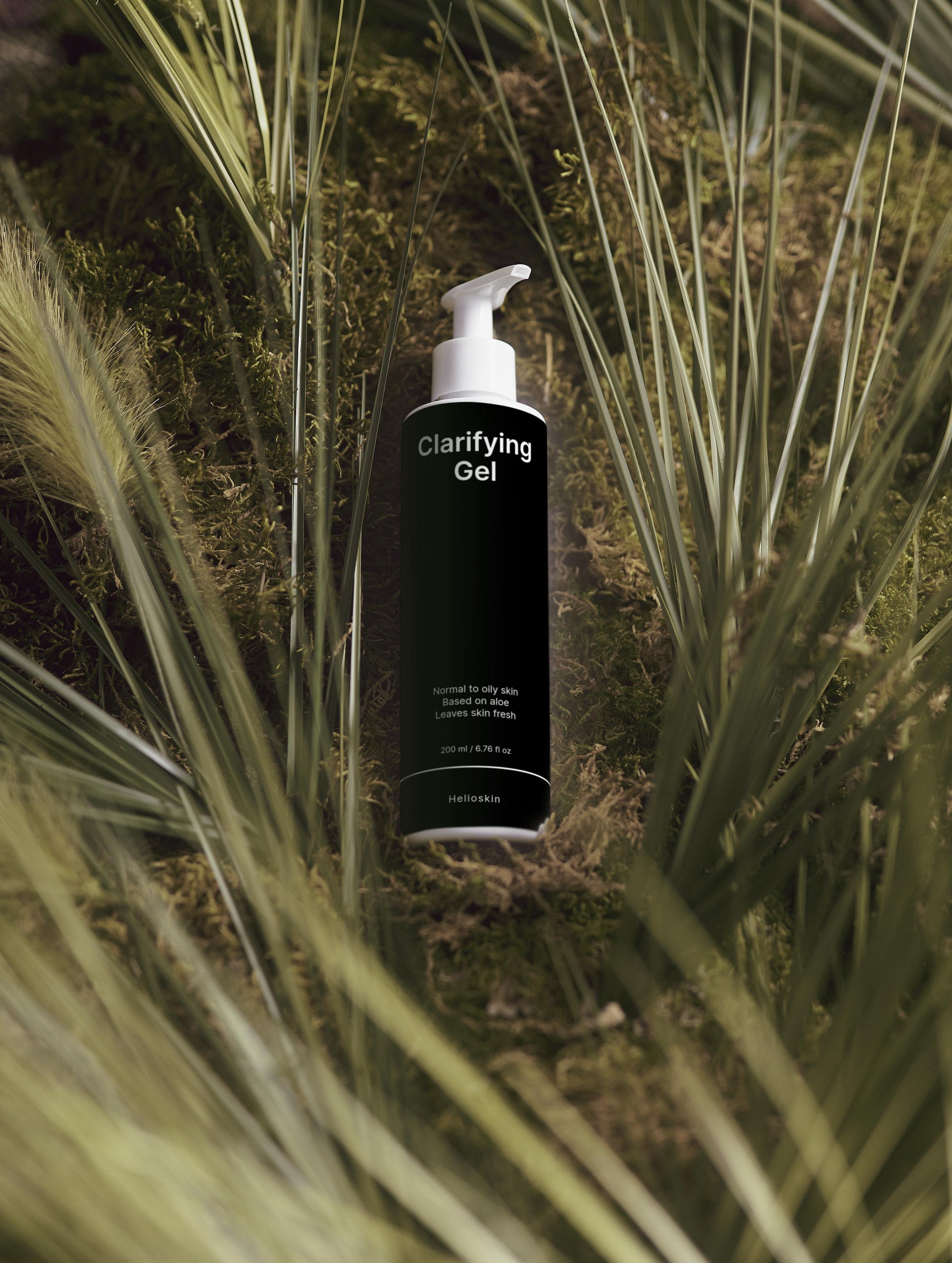 Bottle of Clarifying Gel surrounded by grass and moss