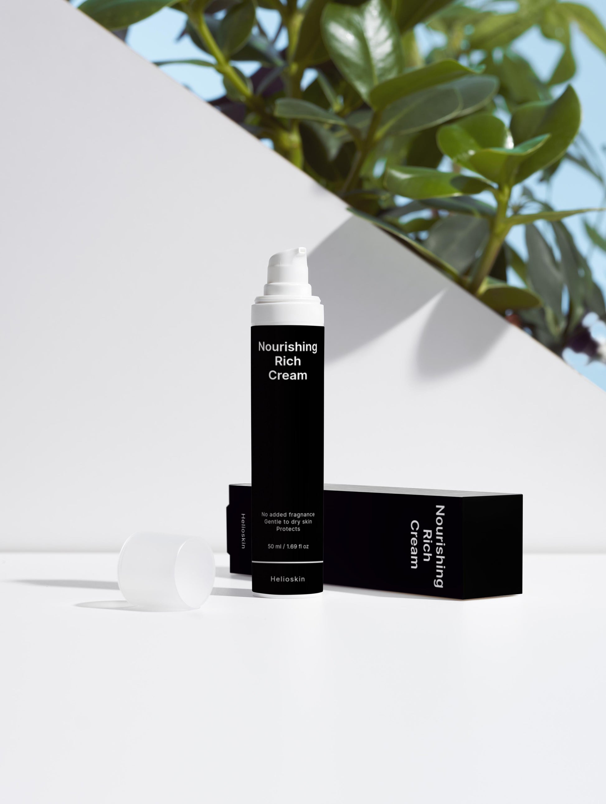 Nourishing Rich Cream packaging with a white background and green leaves.