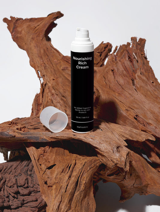 Bottle of Nourishing Rich Cream on a wooden surface