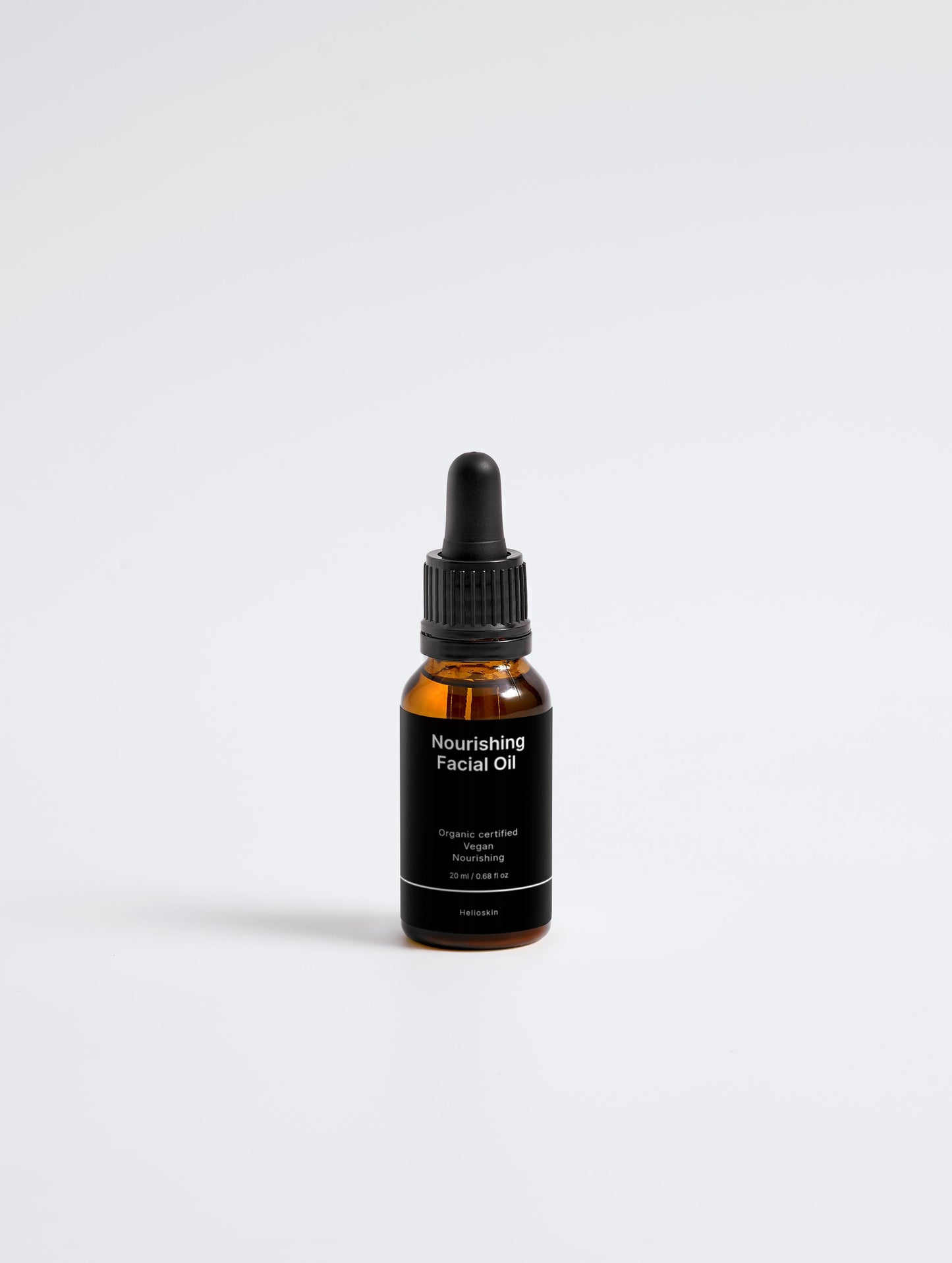 Bottle of nourishing facial oil on a white background