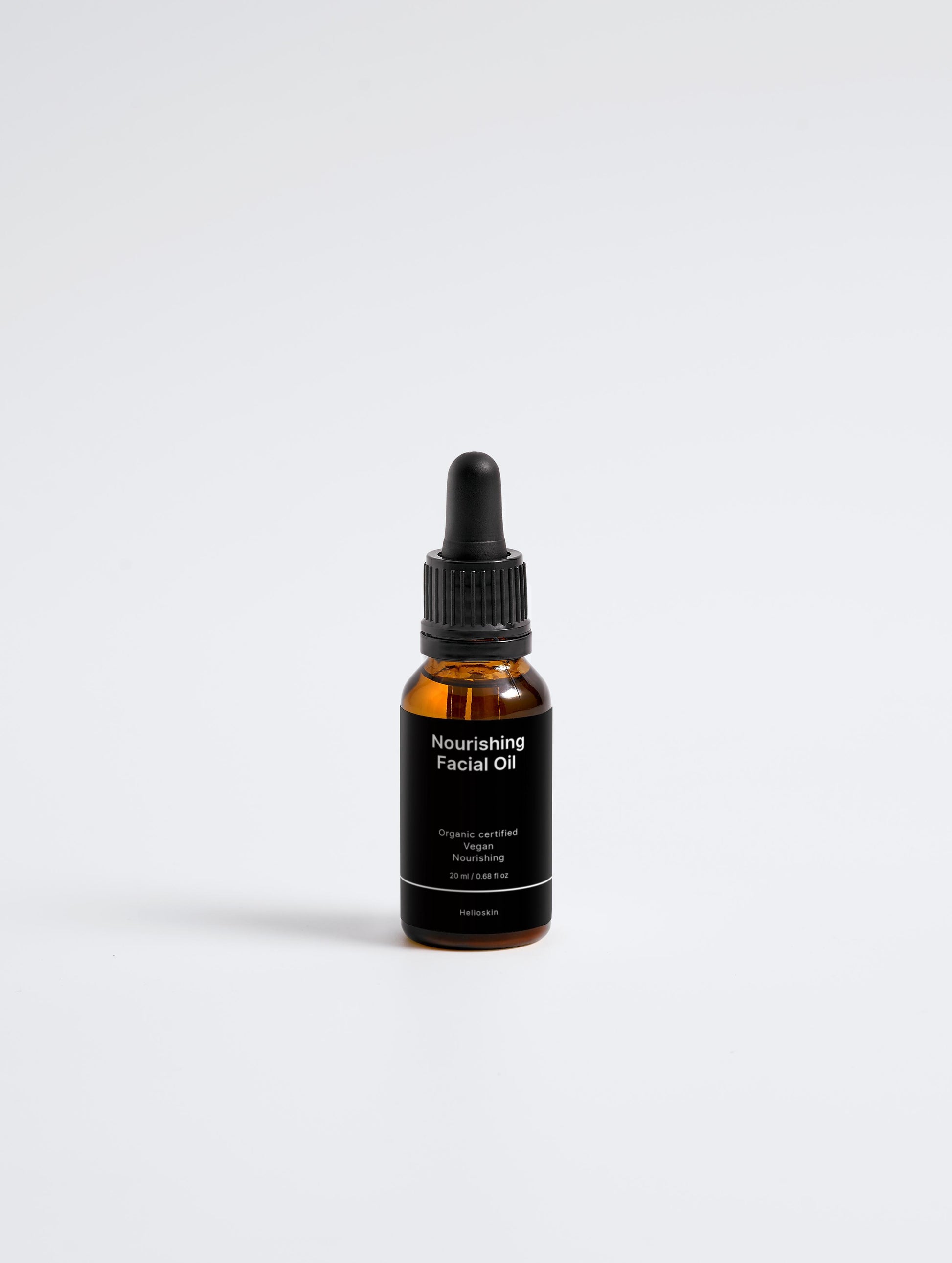 Bottle of nourishing facial oil on a white background