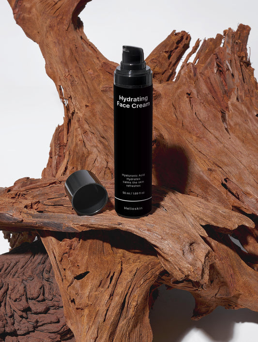 Black hydrating face cream bottle on a wooden surface