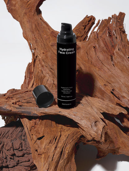 Black hydrating face cream bottle on a wooden surface