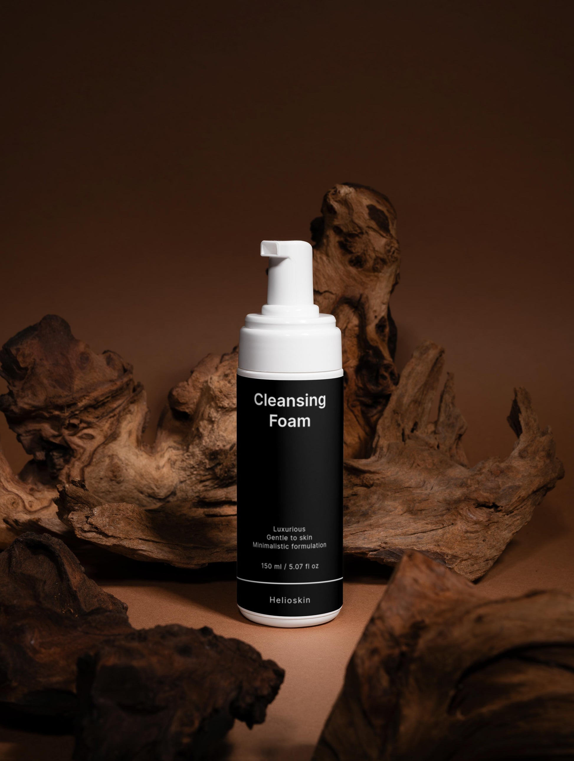 Cleansing foam bottle with pump dispenser on a brown background