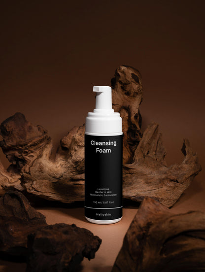 Cleansing foam bottle with pump dispenser on a brown background