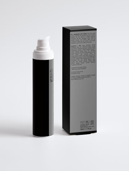 Black and white spray bottle with packaging on a light gray background