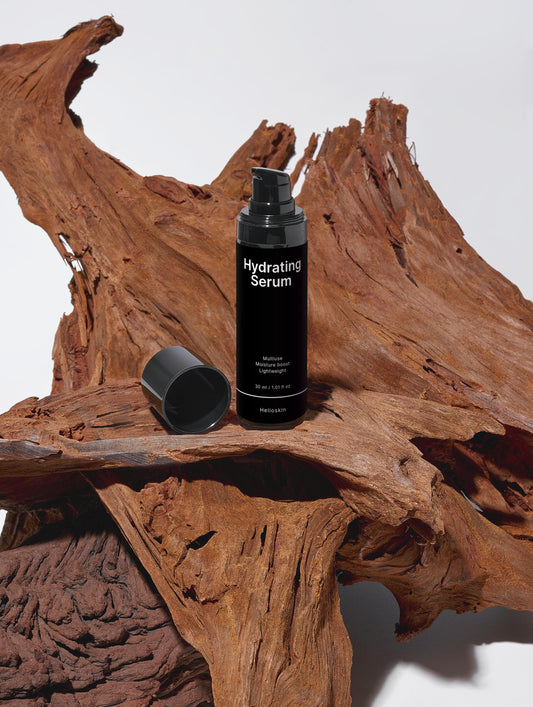 Black hydrating serum bottle on a wooden surface
